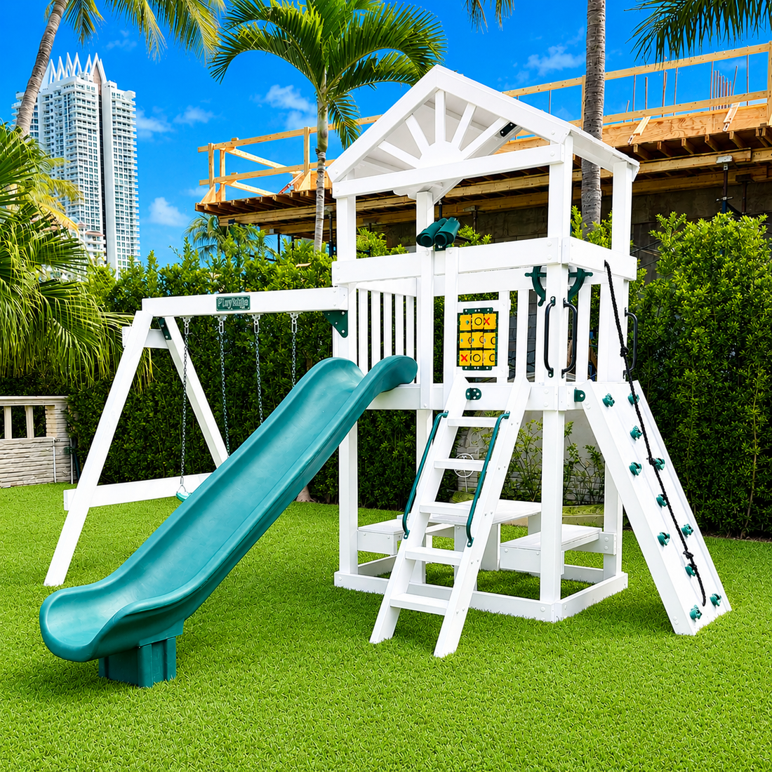 white vinyl swing set with roof, slide, swings and rock wall