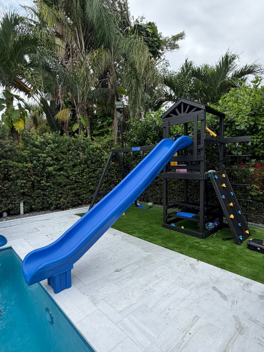 white vinyl swing set with roof, pool slide, swings and rock wall